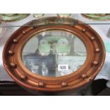 A gold coloured porthole mirror