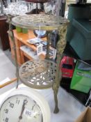 A tripod brass plant stand