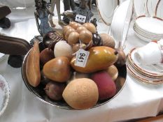 A bowl consisting of a good lot of wooden fruit