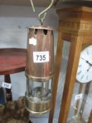 A copper and brass miners lamp