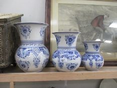 Three blue and white graudated vases