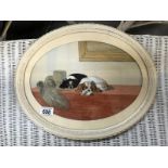 An oval framed picture of a pair of Spaniels