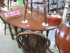 An oak drop leaf table and 4 chirs