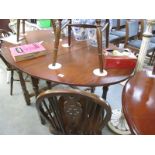 An oak drop leaf table and 4 chirs