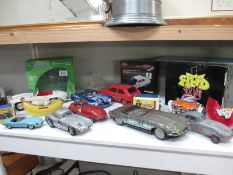 A quantity of boxed and unboxed die-cast and tin plate cars including Corgi,