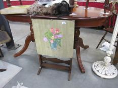 A hand painted fire screen table