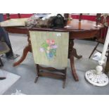 A hand painted fire screen table