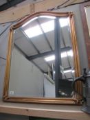 A gilt framed wall mirror