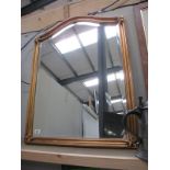 A gilt framed wall mirror