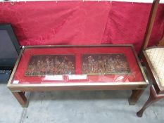 An unusual glass topped table featuring two tiles and marching knights