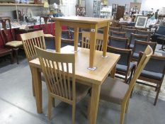 A Morris of Glasgow oak extending dining table, and 4 chairs,