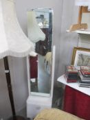 A cheval mirror with drawer