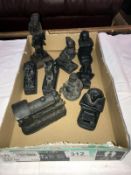 A quantity of black resin ornaments including steam train, Egyptian revival etc.