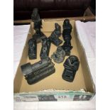 A quantity of black resin ornaments including steam train, Egyptian revival etc.