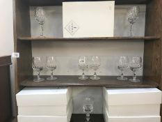 A quantity of Cumbria crystal wine glasses with boxes.