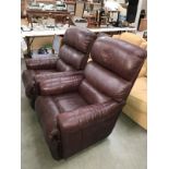 A pair of brown leather recliner chairs