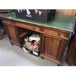 An Edwardian mahogany double pedestal desk with leather inset top.