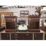 A pair of dark wood stained bedside units
