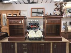 A pair of dark wood stained bedside units