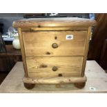 A solid pine 2 drawer bedside chest of drawers