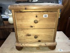 A solid pine 2 drawer bedside chest of drawers