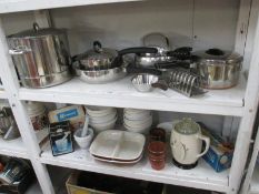 2 shelves of vinatge kitchenalia including stainless steel pans, mixing bowls etc.