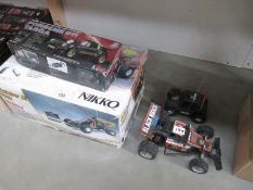 Four radio/remote control cars, some boxed,