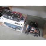 Four radio/remote control cars, some boxed,