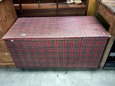 A large blanket box on wheels