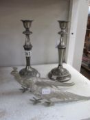 A pair of silver plated candlesticks and a pair of metal pheasants