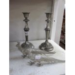 A pair of silver plated candlesticks and a pair of metal pheasants