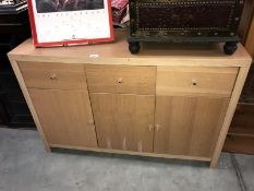 A light oak effect 3 door 3 drawer unit