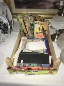 A wooden tray of comics, stamps and other ephemera.