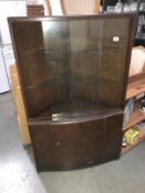 A corner display cabinet with glazed top