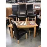 A solid oak dining table & 6 leather chairs
