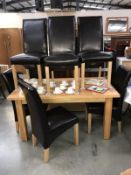 A solid oak dining table & 6 leather chairs