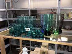 A mixed lot of coloured glass drinking glasses.