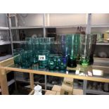 A mixed lot of coloured glass drinking glasses.