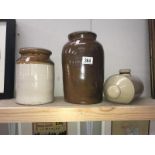 A stoneware hot water bottle and 2 stoneware pots.