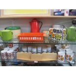 2 shelves of kitchenalia including enamel jugs, pans, flower power mugs etc.