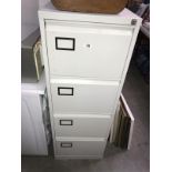 An off white coloured metal 4 drawer filing cabinet