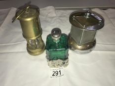 A vintage Pifco night light, a brass miner's lamp and a green glass and silver plate scent bottle.