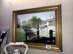 A gilt framed painting of a barge/narrow boat in the lock.