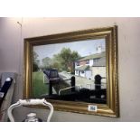 A gilt framed painting of a barge/narrow boat in the lock.