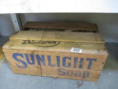 A vintage sealed wooden box of sunlight soap, one part of box lid removed to show contents,