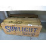 A vintage sealed wooden box of sunlight soap, one part of box lid removed to show contents,