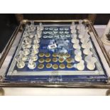 A boxed glass chess and draughts set.