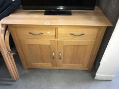 A solid oak 2 drawer cupboard