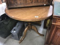 An oak tripod pub table.