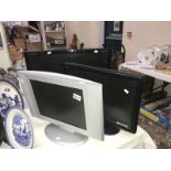 A flat screen television and 2 monitors.